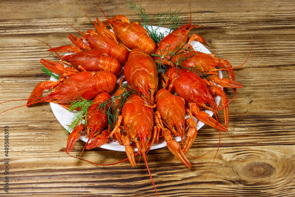 Boiled crayfish in plate on wooden table