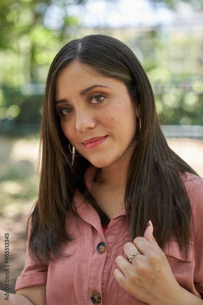 A beautiful Latin woman close up looking straight ahead in a city park A beautiful Latin woman close up looking straight ahead in a city park