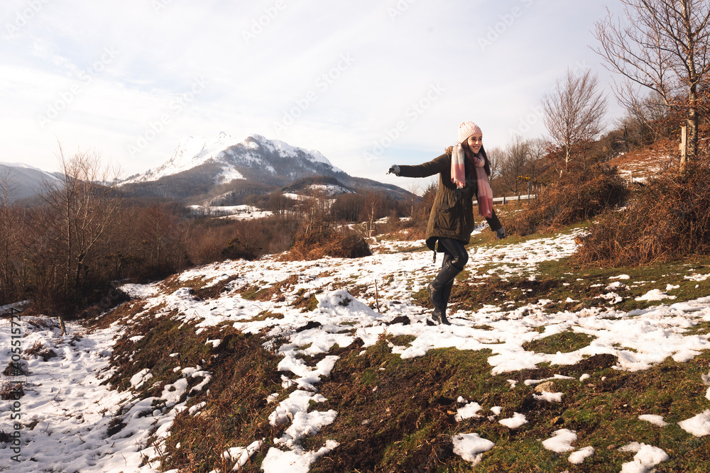 Young woman walking on a snowy mountains