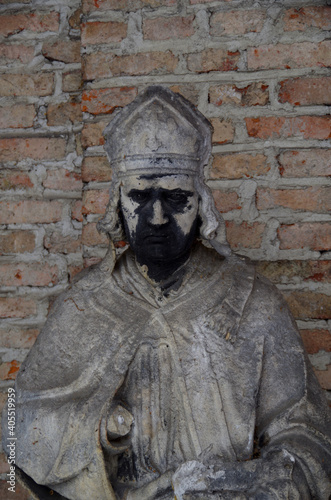 Tombstones and graves, family crypts and vaults on graveyard or cemetery with angels, saints and other statues in winter with snow and lots of symbols and symbolism of eternety and death photo