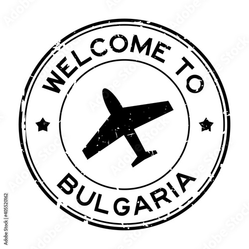 Grunge black welcome to Bulgaria word with airplane icon round rubber seal stamp on white background