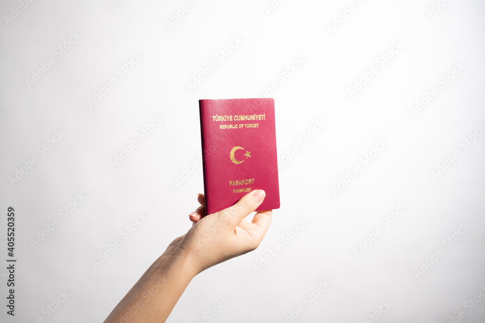 Turkish passport.Turkish standard red passport.Female hand holding a