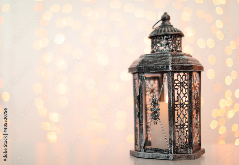 Decorative lantern and blurred lights on background, space for text. Bokeh effect
