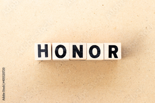 Letter block in word honor on wood background