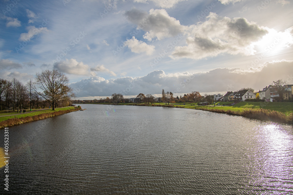 view from bride to dike and beautiful werdersee, a river in bremen, in the sun with amazing sky