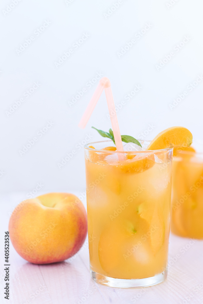 Ripe apricots and glass of apricot juice over white wood background Ripe apricots and glass of apricot juice over white wood background