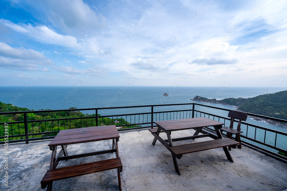 wooden table on rooftop terrace at view point of blue sea coast, lanscape view from mountain peak at Koh Tao islands, Thailand