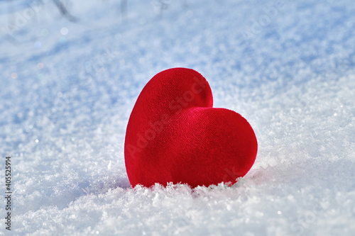 A red hot heart lies on the cold snow.