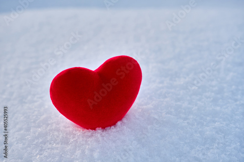 A red hot heart lies on the cold snow.