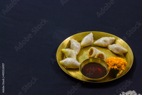 delicious bengali rice flour coconut dumpling served during bengali indian festival of makar sankranti. Photo taken in black background. copy space background for text. photo