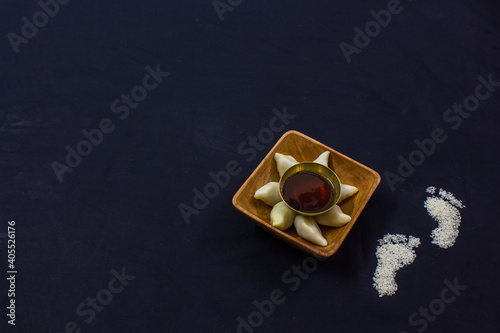 delicious bengali rice flour coconut dumpling served during bengali indian festival of makar sankranti. Photo taken in black background. copy space background for text. photo