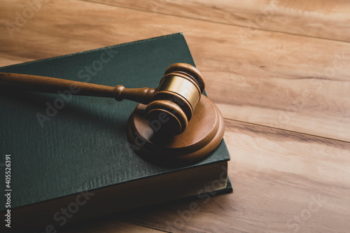 Wooden judge gavel and legal book photo