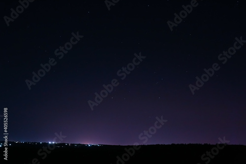 Beautiful view of starry sky over city at night