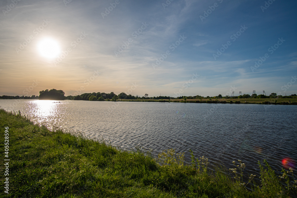 beautiful werdersee, a river in bremen, with weserstadium in the background at sunset