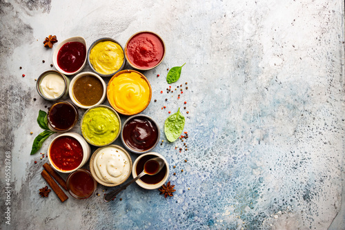 Set of different bowls of various dip sauces, top view photo