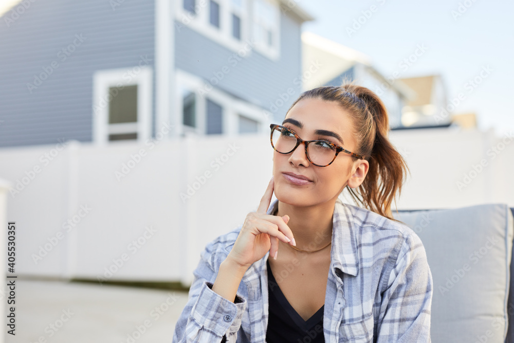 female outside of house in lounge chair thinking about a decision 0153 female outside of house in lounge chair thinking about a decision 0153