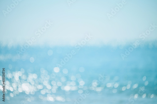 Abstract bokeh background from summer blue sea water at the beach