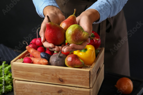 Fototapeta Naklejka Na Ścianę i Meble -  Farmer holding fresh ripe pears, closeup view. Harvesting time