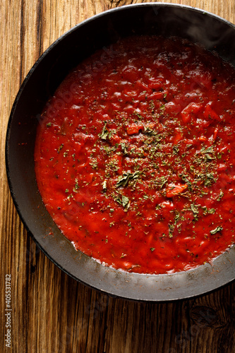 Homemade traditional tomato sauce sprinkled with dried oregano top view