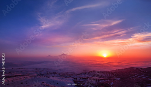 Beautiful panoramic view on the mountains , sunset with long exposure clouds. The Ararart mountains in a clouds and fog. 