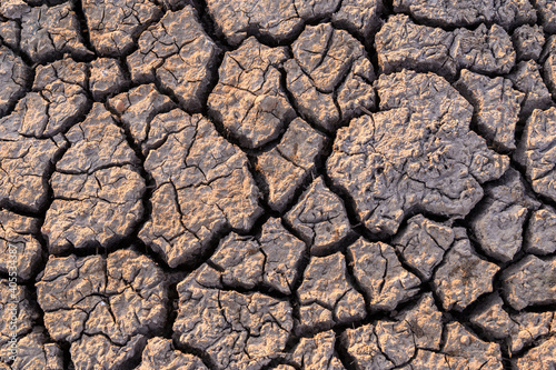 Cracked soil for background and texture material, arid waterless area, climate change concept