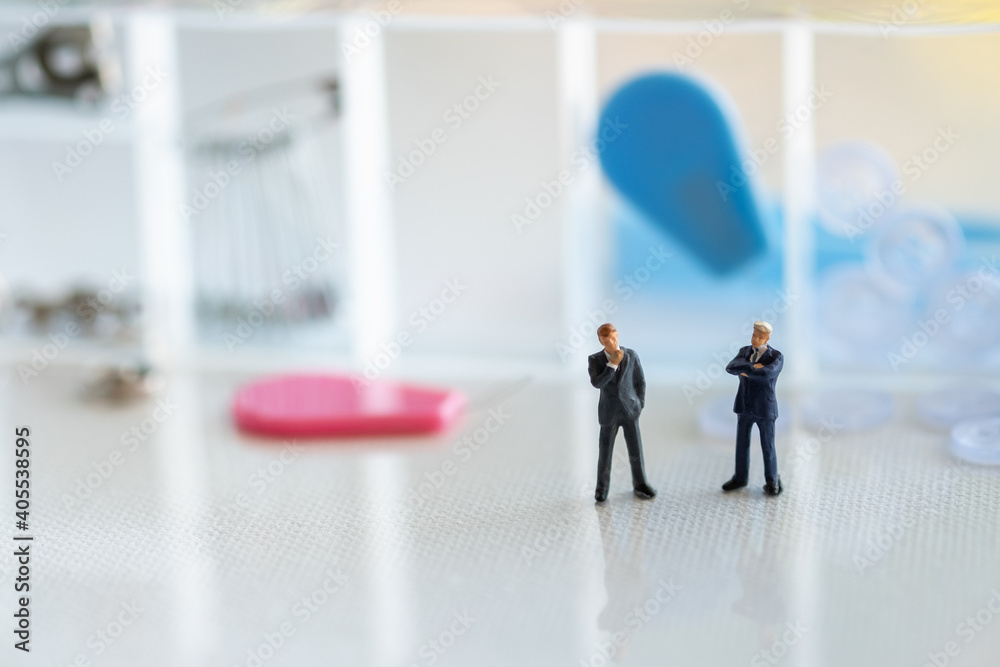 Miniature 2 businessmen stand behind the repair kit, cloth mats Miniature 2 businessmen stand behind the repair kit, cloth mats