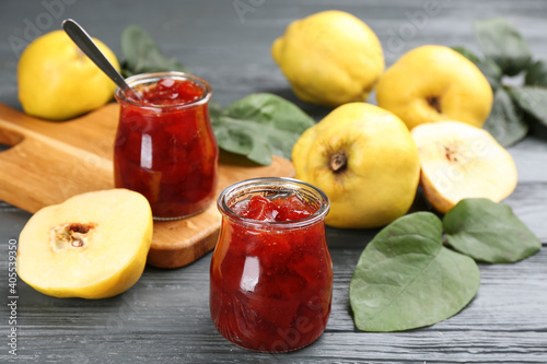 Fototapeta Naklejka Na Ścianę i Meble -  Delicious quince jam and fruits on grey wooden table