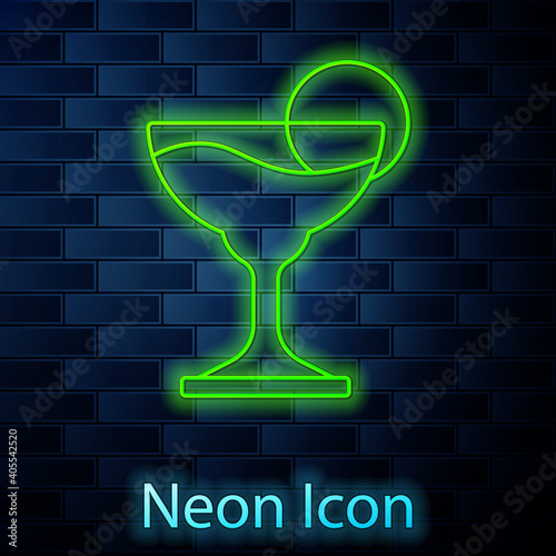 Glowing neon line Margarita cocktail glass with lime icon isolated on brick wall background. Vector.