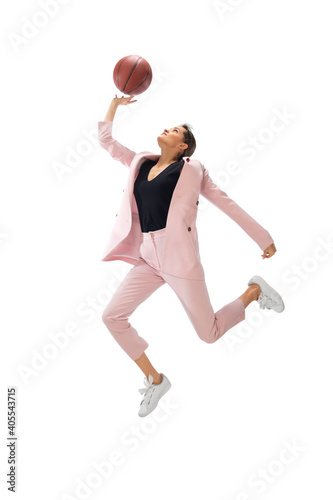 Basketball. Happy young woman dancing in casual clothes or suit, remaking legendary moves and dances of celebrity from culture history. Isolated. Action, motion, fame concept. Creative occupation.