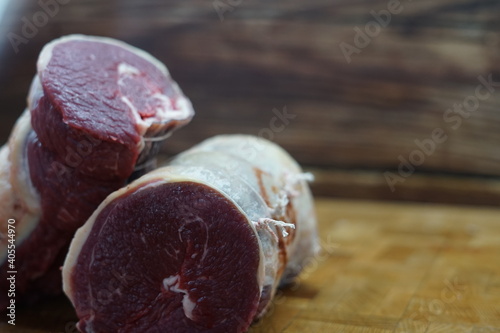 Roast beef on wood butchers block