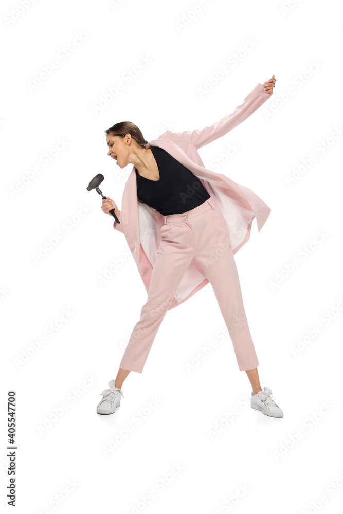 Rockstar. Happy young woman dancing in casual clothes or suit, remaking legendary moves and dances of celebrity from culture history. Isolated. Action, motion, fame concept. Creative occupation.