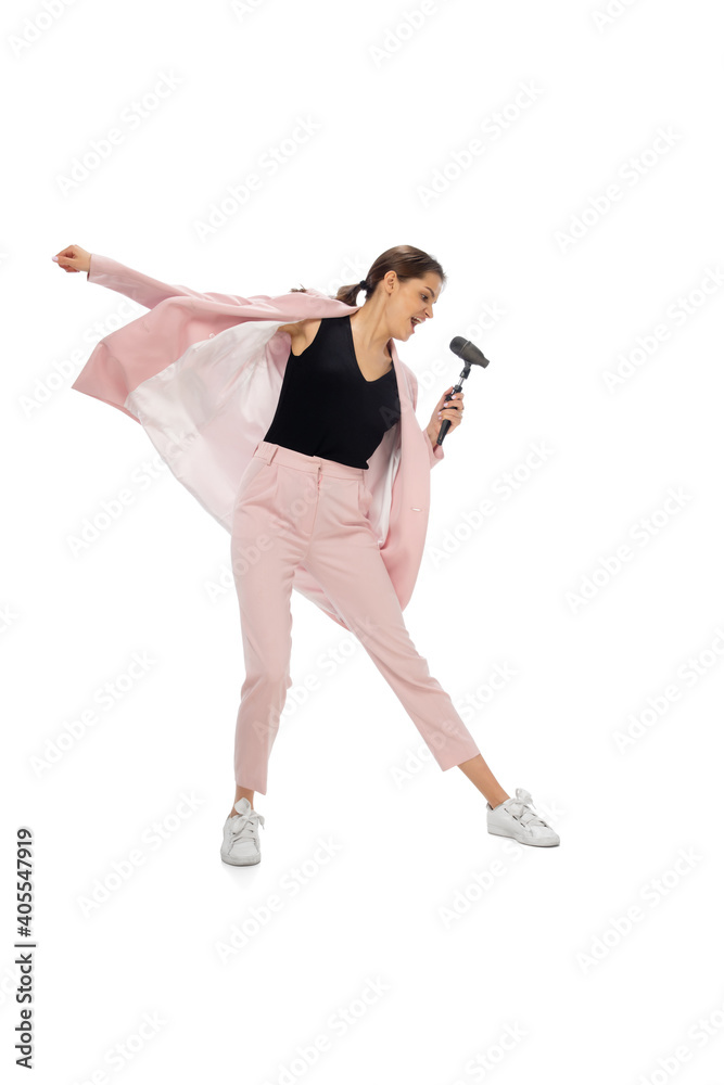 Rockstar. Happy young woman dancing in casual clothes or suit, remaking legendary moves and dances of celebrity from culture history. Isolated. Action, motion, fame concept. Creative occupation. Rockstar. Happy young woman dancing in casual clothes or suit, remaking legendary moves and dances of celebrity from culture history. Isolated. Action, motion, fame concept. Creative occupation.