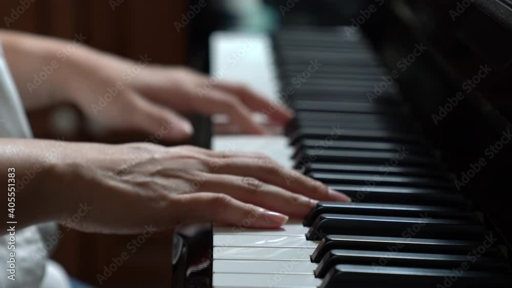 Young woman playing piano, learning to play piano, taking piano lessons Young woman playing piano, learning to play piano, taking piano lessons