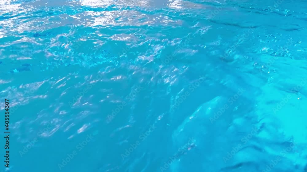 Closeup shot of ripples on the water surface at swimming pool. Beautiful under water background or backdrop. Closeup shot of ripples on the water surface at swimming pool. Beautiful under water background or backdrop.