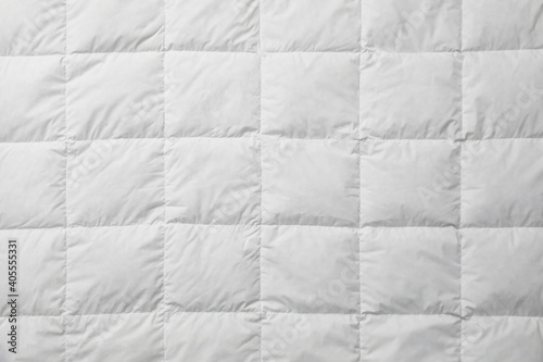Soft quilted blanket as background  top view