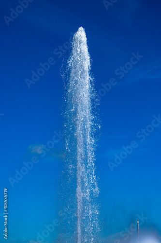 Water jet from a fountain in abstract design on blue sky background. Urban landscape.  Concept.