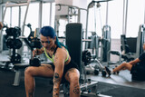 tattooed woman training in gym
