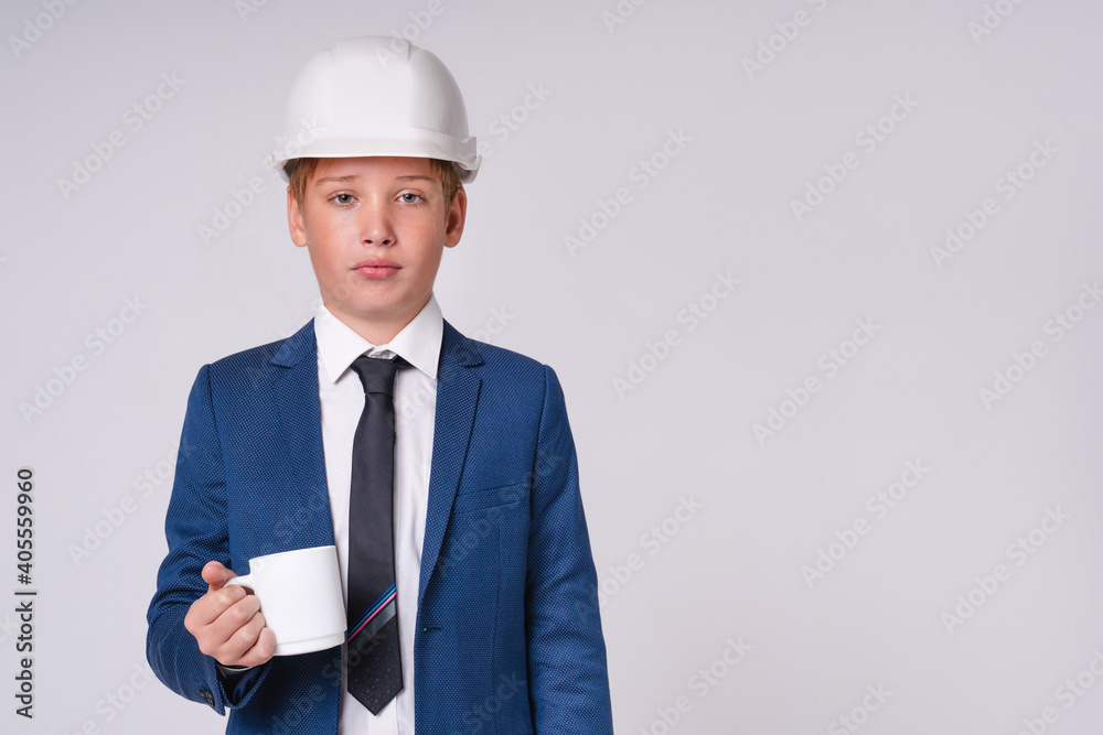 Tired after working preteen caucasian boy future engineer in hardhat with cup of coffee isolated over grey background Tired after working preteen caucasian boy future engineer in hardhat with cup of coffee isolated over grey background
