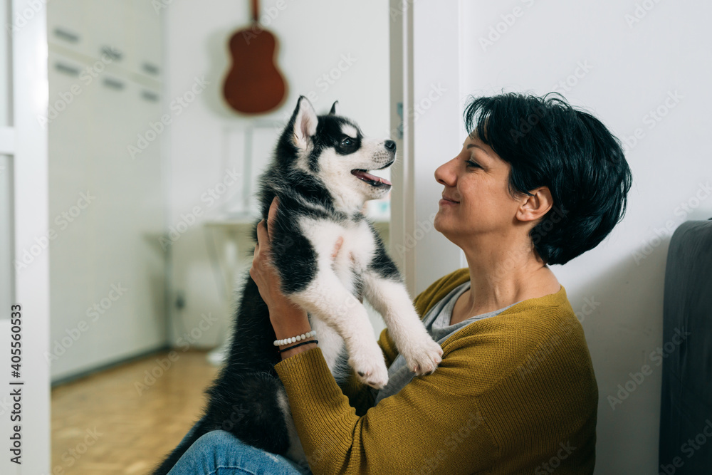 woman cuddling with her dog at home
