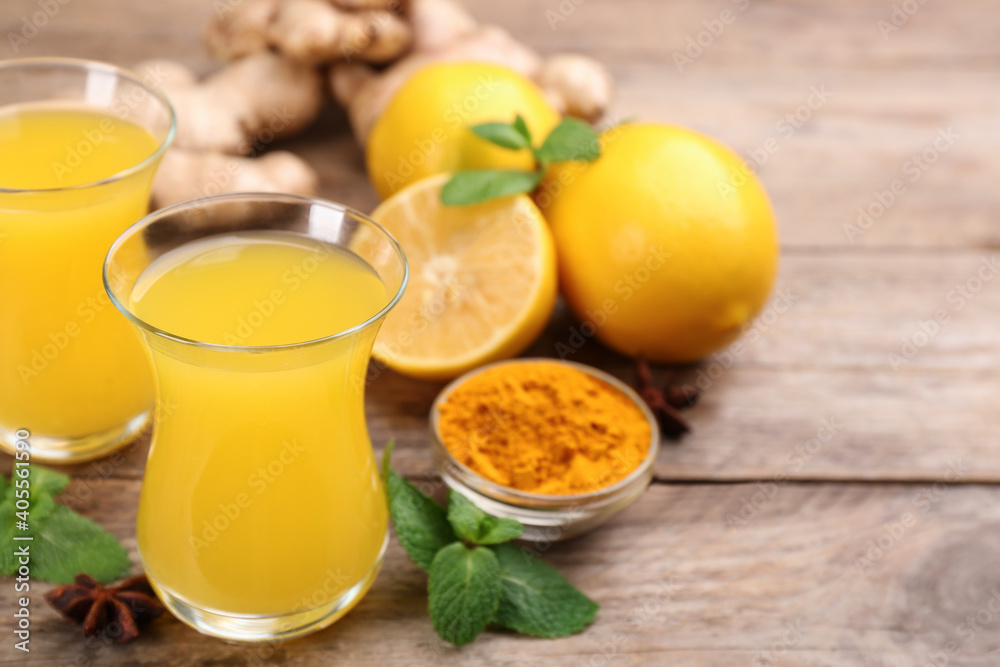 Immunity boosting drink and ingredients on wooden table. Space for text Immunity boosting drink and ingredients on wooden table. Space for text