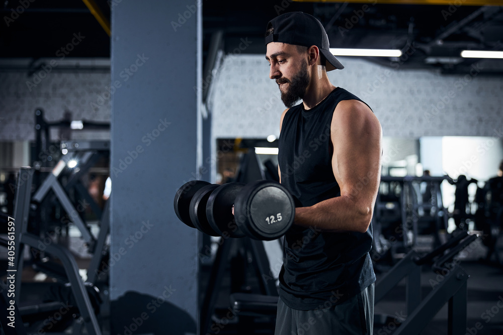 Muscular man is lifting two heavy dumbbells Muscular man is lifting two heavy dumbbells