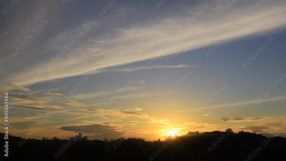 Time lapse of sunset with clouds and high rise building silhouettes on horizon Time lapse of sunset with clouds and high rise building silhouettes on horizon