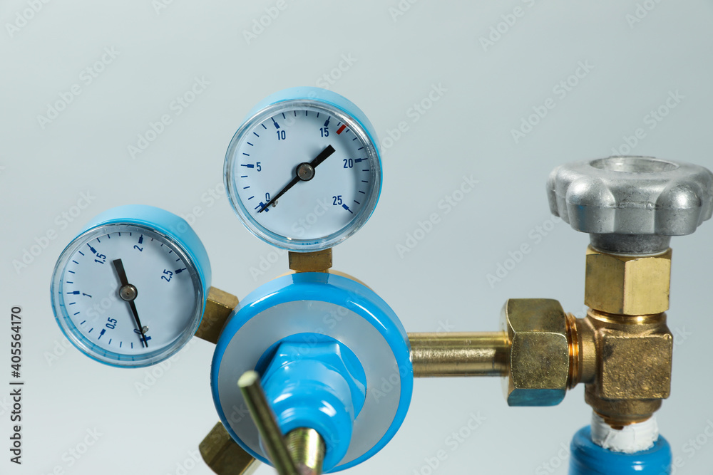 Pressure gauge of medical oxygen tank on light grey background, closeup Pressure gauge of medical oxygen tank on light grey background, closeup