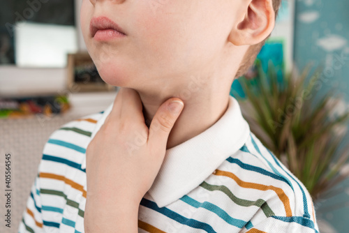 sore throat in a child. the child has a sore throat. signs of a cold in children