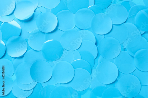 Many light blue confetti as background, top view