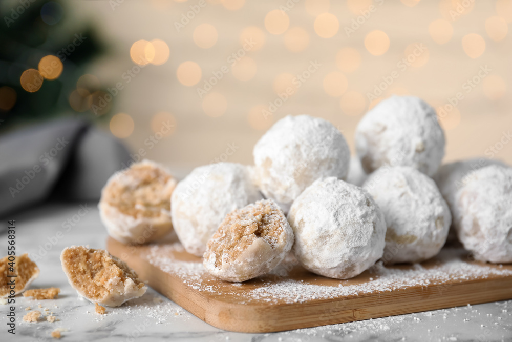 Tasty snowball cookies on wooden board, closeup. Christmas treat Tasty snowball cookies on wooden board, closeup. Christmas treat