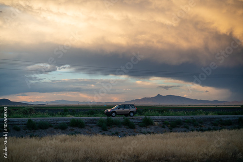 A car drives on on Interstate 10 in Arizona at sunset