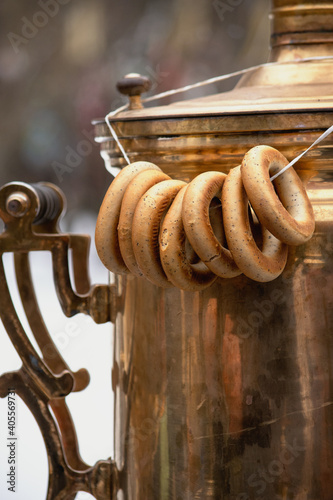 Sushki on a string hanging on old copper Russian samovar