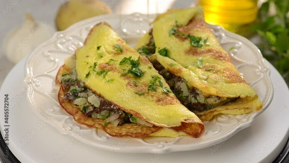 putting parsley over stuffed omelette putting parsley over stuffed omelette