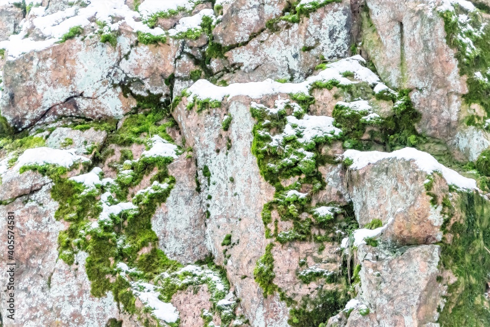 Granite rocks in winter, green moss and snow. Granite rocks in winter, green moss and snow.